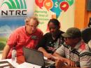 Brian Machesny, K1LI/J75Y (left), works with two students during the Hamsphere exercise in Dominica.